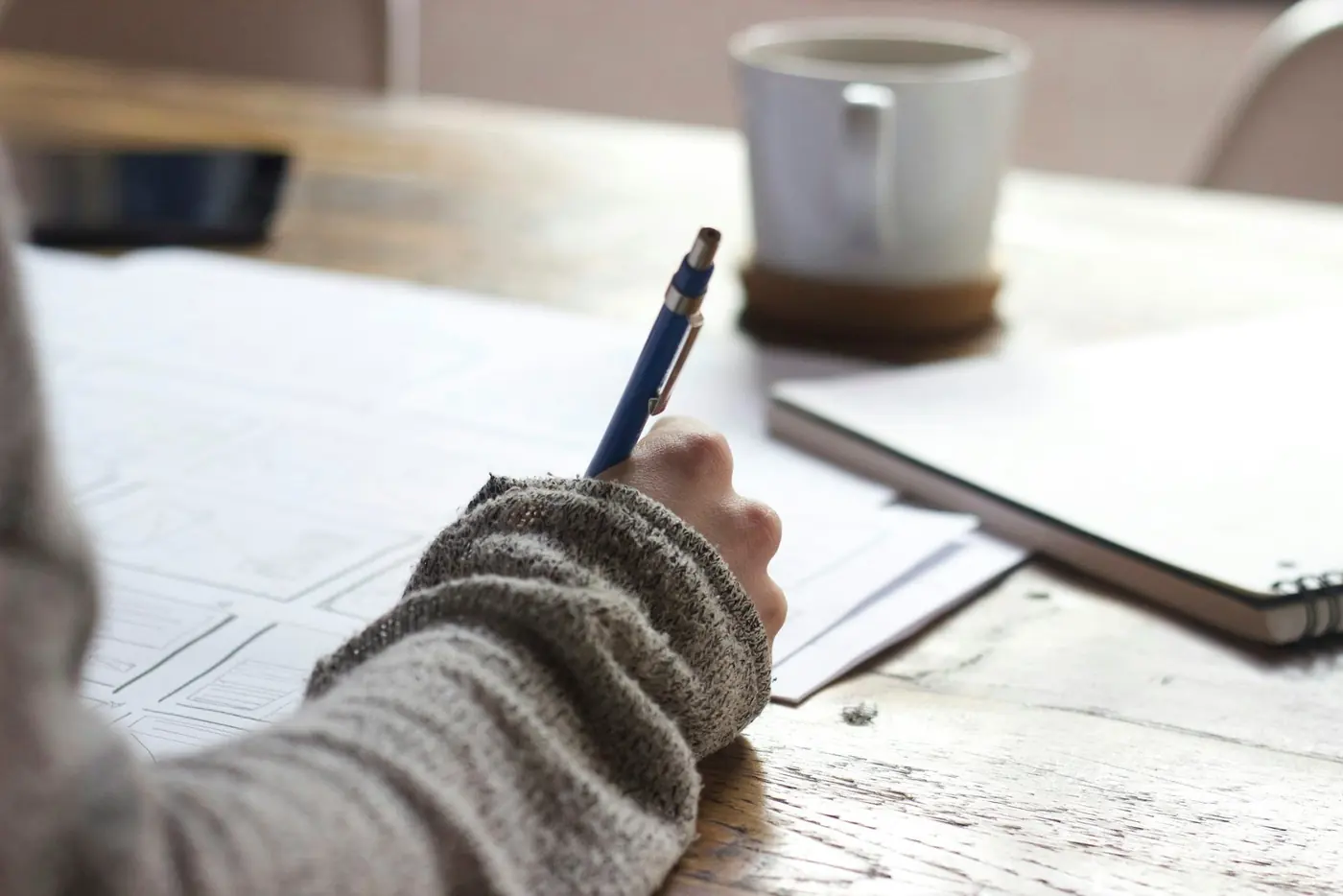 Student writing notes while preparing for the PU board examination